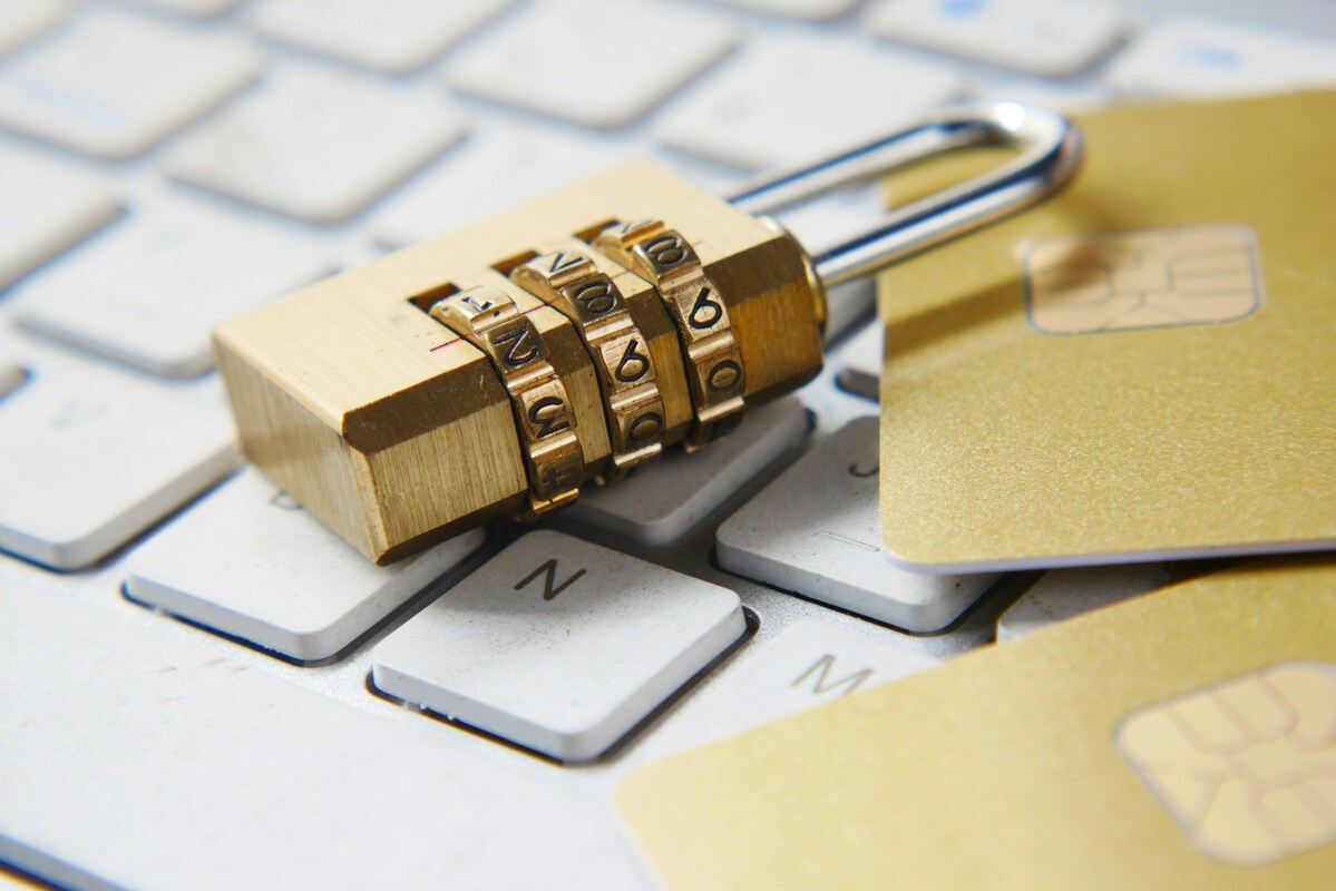 A golden padlock sitting on top of a keyboard